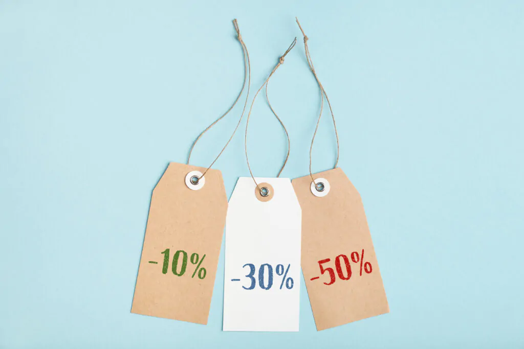 Set of tags with different percent discounts on a blue background. Seasonal sale in stores